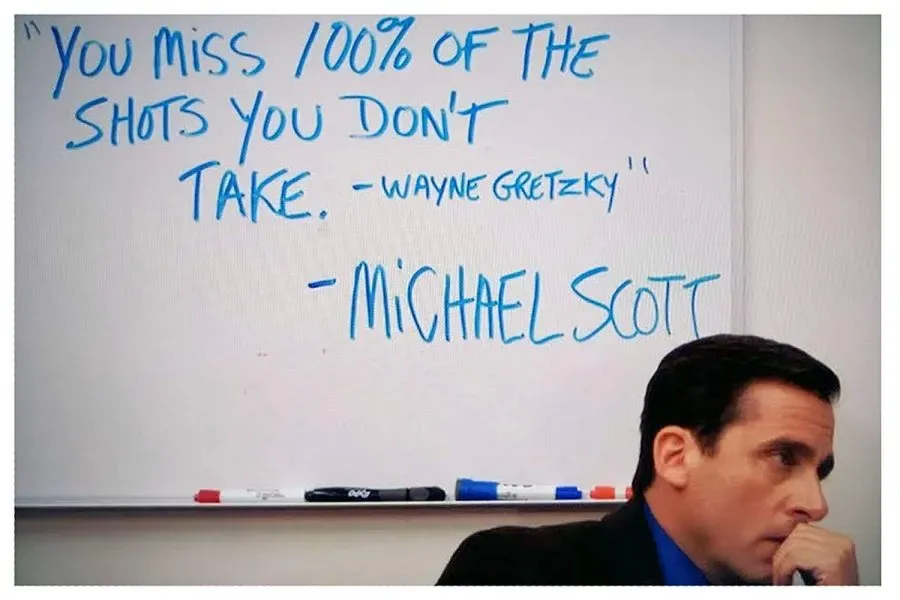 Michael Scott from The Office sits in front of a quote: "You miss 100% of the shots you don't take. Wayne Gretzky." - Michael Scott